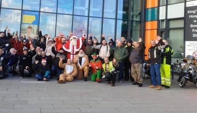 Sutton In Ashfield Scooter Club's' Prezzies at the Mill' event. Members are seen outside Kings Mill Hospital after the run in 2019. Robert Wilkins is at the front seated in his reindeer suit.