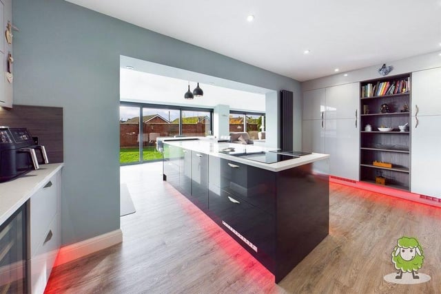 A second shot of the classy kitchen, which also features expansive windows, giving views of the back garden at the £525,000 property.