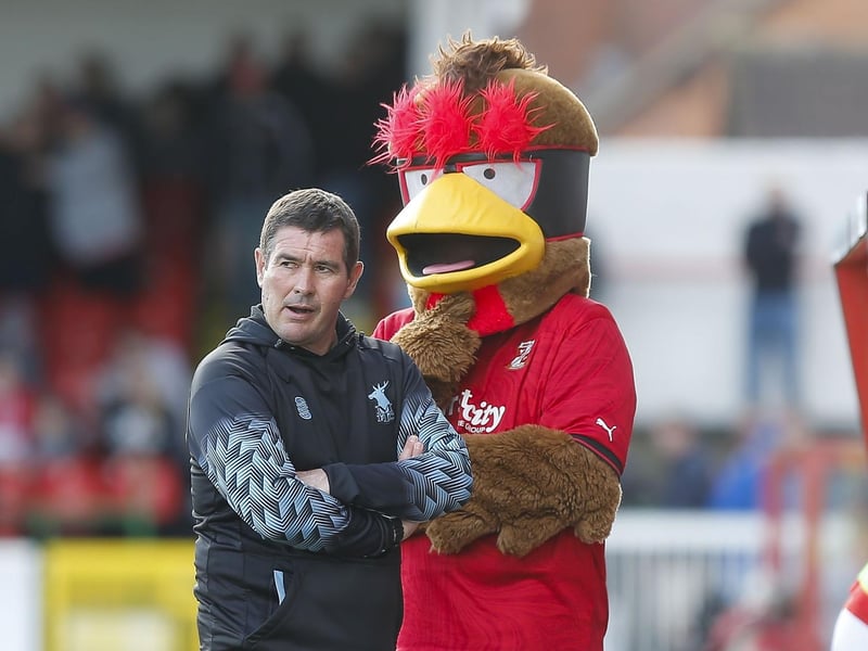 The Swindon mascot keeps an eye on Nigel Clough.