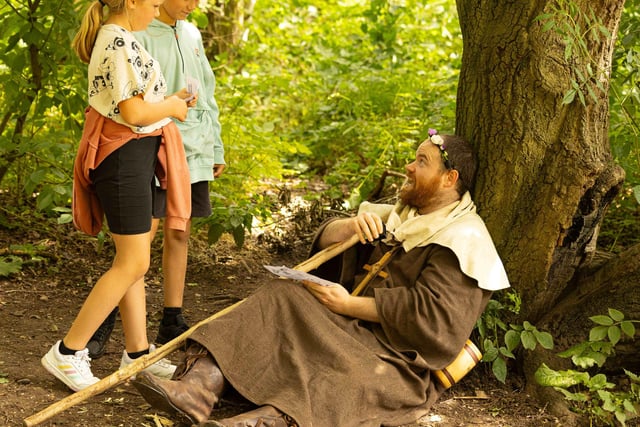 Friar Tuck shares a joke with two young visitors to Sherwood Forest on Sunday, July 30.