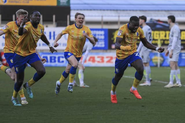 Mansfield Town defender Deji Oshilaja (23) celebrates scoring a late winner during the Sky Bet League One match against Barnsley FC at the One Call Stadium, 15 March 2025, Photo credit Chris & Jeanette Holloway / The Bigger Picture.media