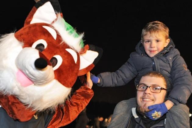 Jenson and Chris Handley high-five a costumed character at the Mansfield Woodhouse fireworks event back in 2018