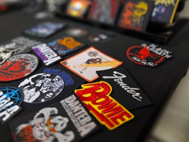 Some of the stock for sale includes iron-on patches featuring bands and pop culture themes.