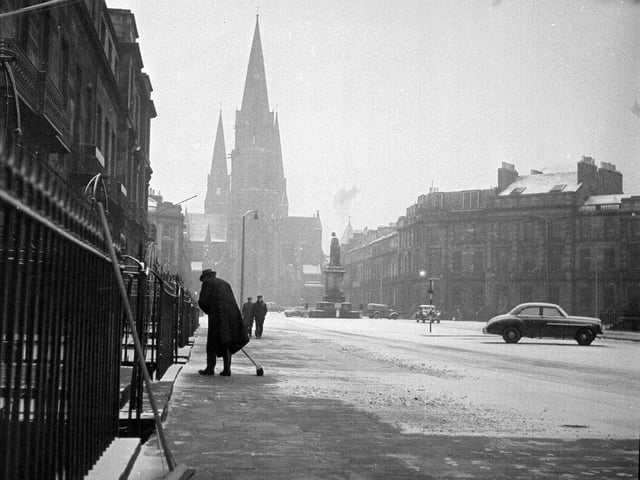A resident clears the pavement of snow in Melville Street in 1962.