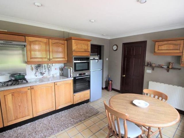 The kitchen is a welcoming space and comes with a range of appliances, including an integrated double electric oven and four-ring gas hob with extractor fan above. There is space for a free-standing fridge/freezer.