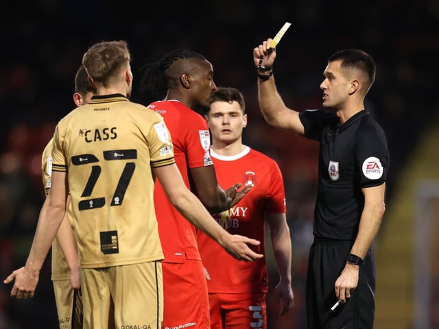 Omar Beckles of Leyton Orient is shown a yellow card.
