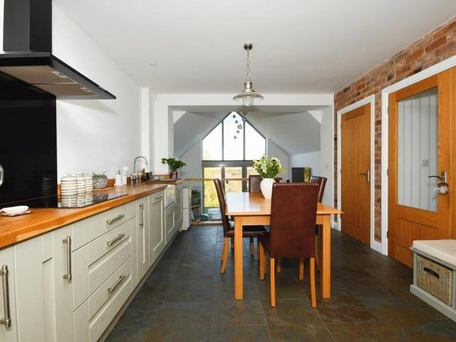 Behind the feature window sits this contemporary kitchen, which is fit for any family with culinary leanings. It is such a generous size that there is plenty of room for a dining or breakfast table.