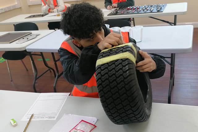 Student William Ruales tackles the tyre check challenge.