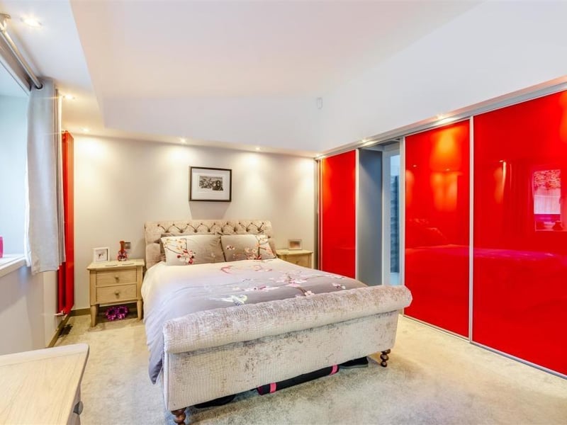 Extensive, fitted wardrobes, with hanging rails, drawers and shelving, are a major asset in the master bedroom.