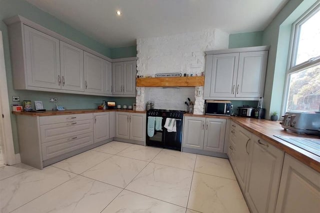 The kitchen, which is attached to the dining area, is bright and spacious. It comes with an integrated dishwasher and space for a range cooker, not to mention a host of storage units and cupboards.