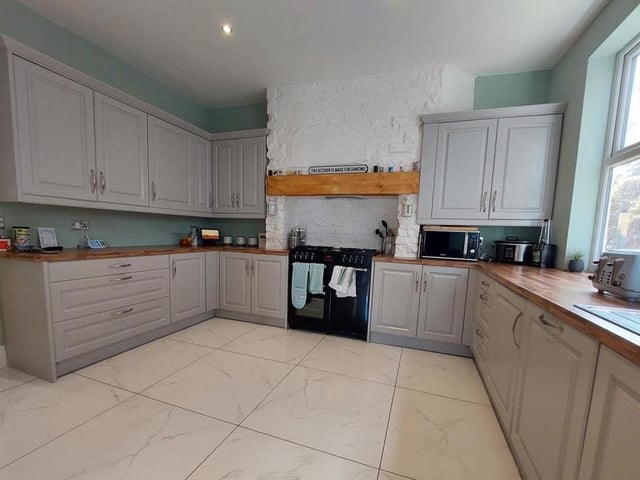 The kitchen, which is attached to the dining area, is bright and spacious. It comes with an integrated dishwasher and space for a range cooker, not to mention a host of storage units and cupboards.