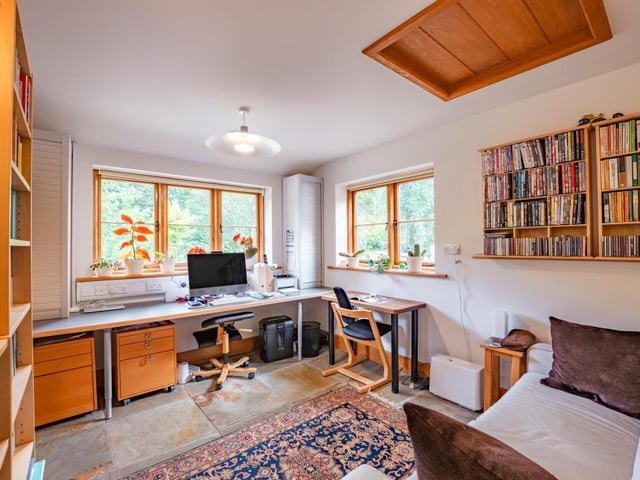 This ground-floor room is currently serving as an office, which could be perfect for anyone working from home. It has a slate floor, fitted desks and windows overlooking the established gardens and driveway.