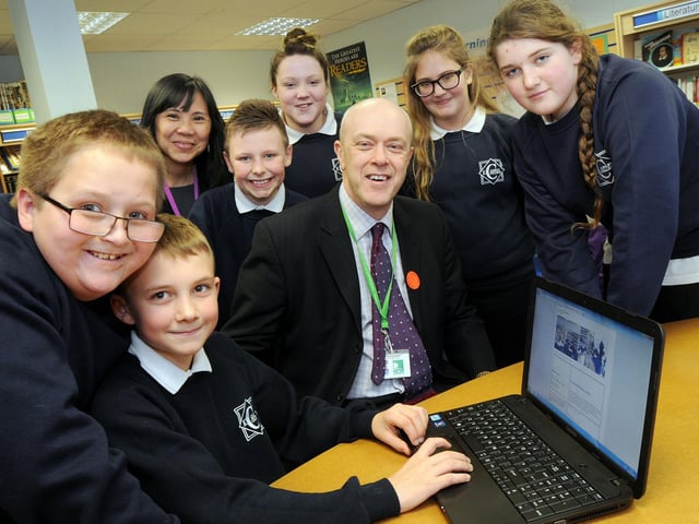 Year 7 pupils from Kirkby College pictured with Coun. John Knight, leader of Ashfield District Council and Jo Carroll, in their school library which is to benefit from laptop computers. The picture was taken in 2013.
