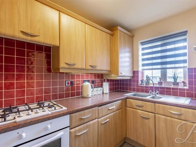 Our first look at the kitchen, which is smart in appearance and is fitted with a range of matching cabinets and units. Not forgetting a work surface, gas hob and inset sink and drainer.