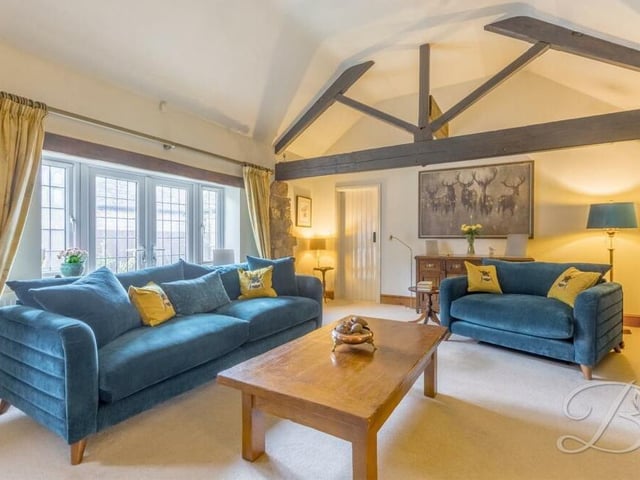 The first stop on our tour of the Kirkby Hardwick barn conversion is this lovely, large lounge, complete with high ceilings and ceiling beams. A set of French doors leads outside to the garden.