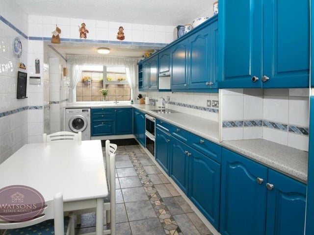 Moving now into the kitchen, which is a lengthy space with a range of matching wall and base units, plus work surfaces incorporating a stainless steel sink and drainer unit. There is an integrated oven with extractor over, a tiled floor and plumbing for a washing machine