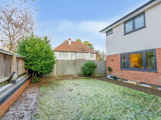 Let's take a look outside now, starting with the well-maintained, lawned garden at the back of the house which is enclosed by a fence.