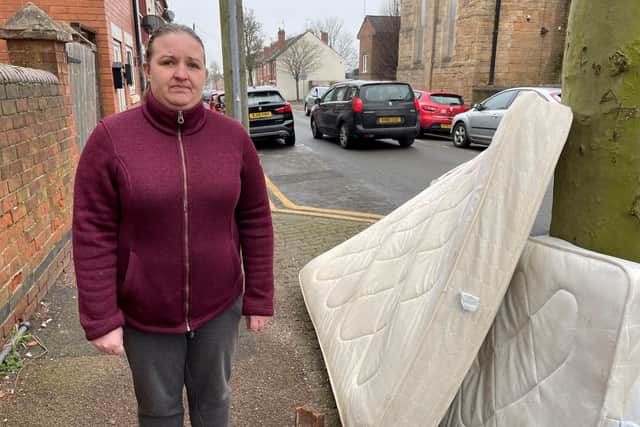 Coun Deakin next to the dumped mattresses