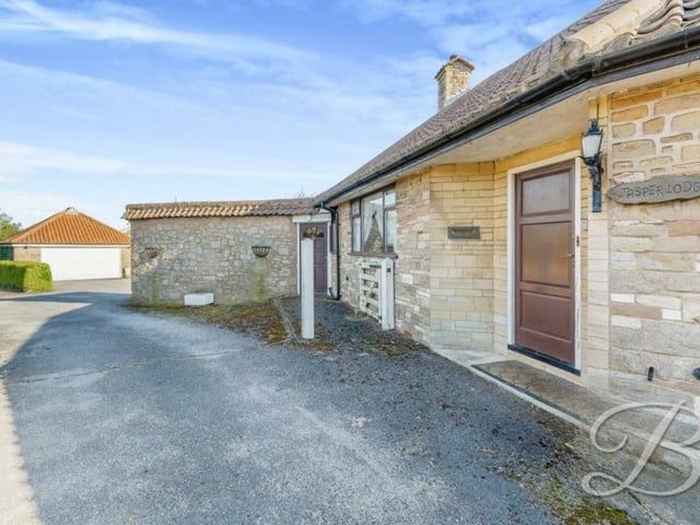 The driveway leads to the welcoming front door.