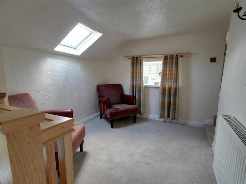Here is the landing at the top of the stairs at the £700,000-plus farmhouse. It has a seating area and useful built-in storage.