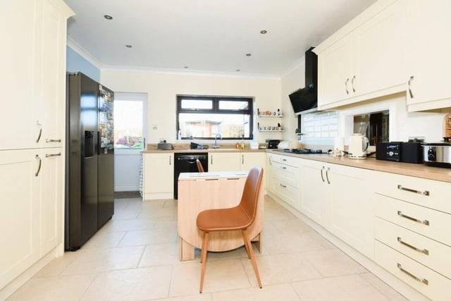The sparkling kitchen from a different angle. Nearby is a utility room, which has additional storage and also plumbing for a washing machine and tumble dryer.