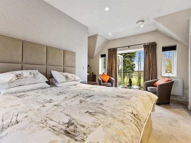 The master bedroom suite boasts two sets of French doors to Juliet balcony and balcony.