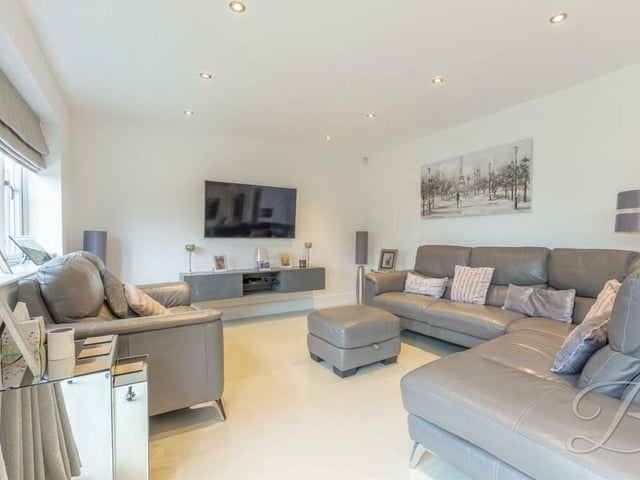 The open-plan section also includes this smart living area, which has ample space for relaxing and entertaining. Underfloor heating and downlights add to the sense of style.