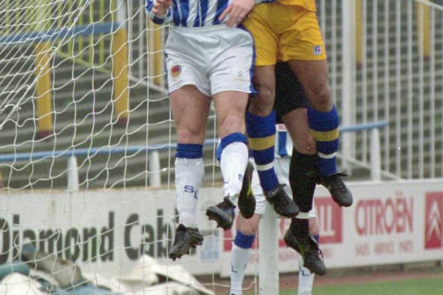 Isyeden Christie challenges for the ball against Chester.