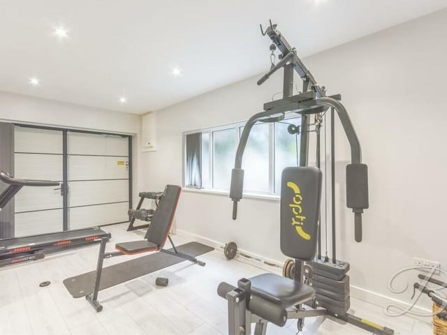 An integral garage on the ground floor of the Lichfield Lane property has been wonderfully converted into this home gym.
