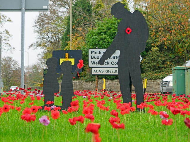 A new display addition features a soldier receiving a poppy from children.