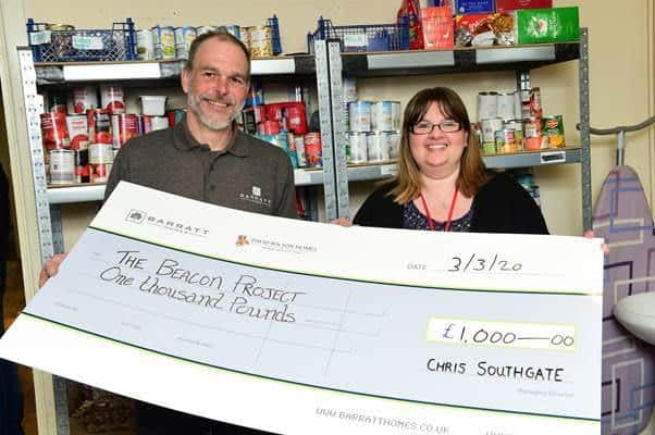 James Double and Louisa Hillman with the cheque from Barratt and David Wilson Homes.