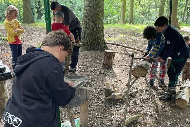 Kai teaching more children new bushcraft skills on one of the Rika courses.