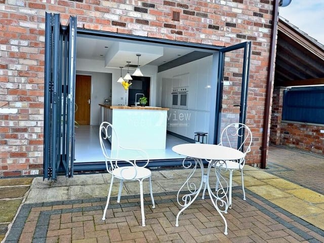 Relax with a cup of coffee or a glass of beer or wine on this patio area outside the kitchen.