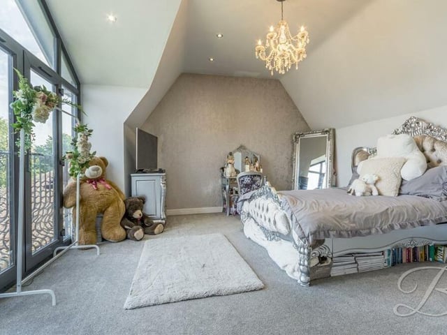 The first bedroom to have a look at is this grand specimen, complete with a Juliet balcony, carpeted floor, downlights and fitted wardrobe. It also has access to an en suite and a walk-in wardrobe.