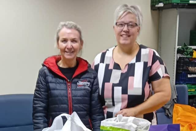 Eastwood Slimming World consultant Caroline Redford hands over a donation to bureau manager Rachel Laurenson. Photo: Submitted
