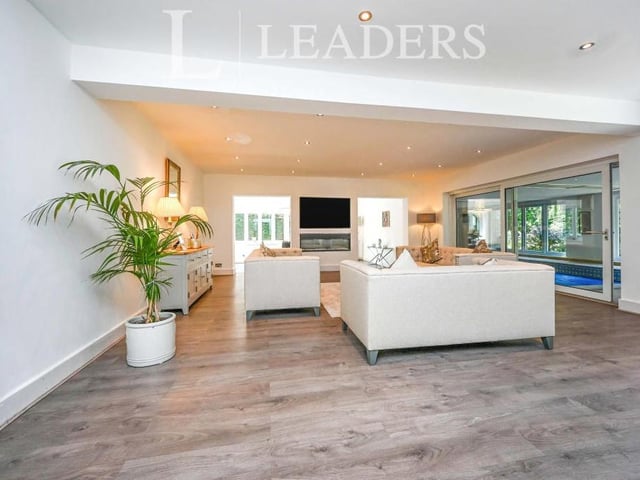 The luscious lounge or sitting room offers space and light in abundance. It has a wall-mounted feature electric fire, a bar area and sliding patio doors to the swimming pool, sauna and jacuzzi. Steps lead down to the dining room.