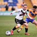 Aaron Lewis, playing for Newport County is challenged by Tyrese Sinclair of Mansfield Town during the Sky Bet League Two match between Mansfield Town and Newport County at One Call Stadium on 9th April 2021. Photo by Nathan Stirk/Getty Images.