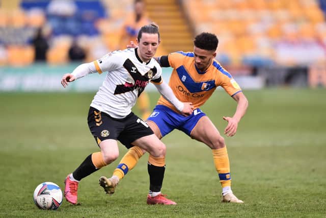 Aaron Lewis, playing for Newport County is challenged by Tyrese Sinclair of Mansfield Town during the Sky Bet League Two match between Mansfield Town and Newport County at One Call Stadium on 9th April 2021. Photo by Nathan Stirk/Getty Images.
