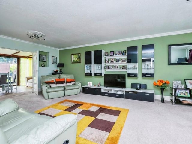 Let's open our photo gallery in the largest room at the £375,000 Selston bungalow. It is the inviting lounge, which is the main reception room and opens to the left into the dining room. Features include a carpeted floor and coving to the ceiling.