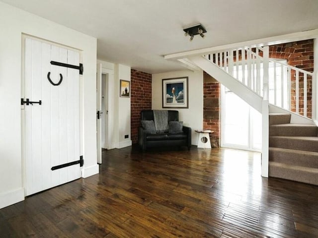 A further reception room on the ground floor is this splendid hall, with open stairs, a stable door to the side and access to the downstairs WC