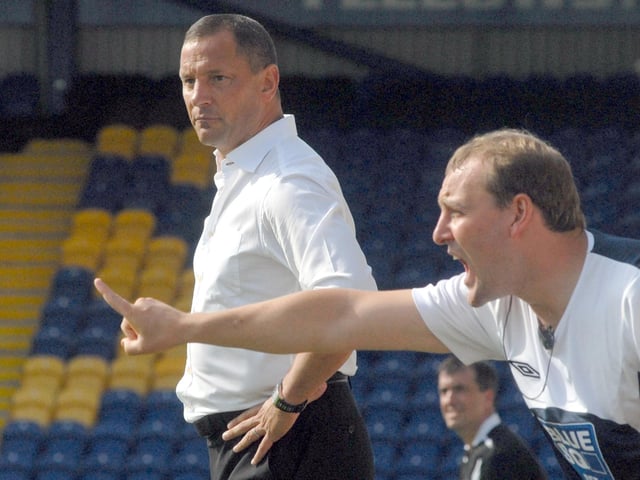 David Holdsworth looks on.