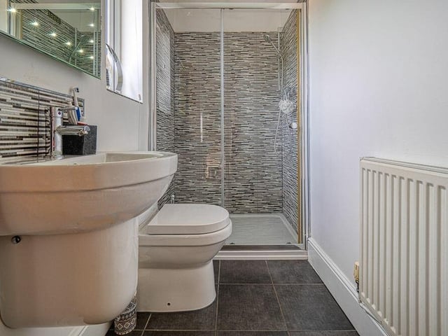The first floor of the Mansfield Road property also hosts this shower room, with shower cubicle, pedestal sink, low-level toilet, heated towel-rail and tiled floor.
