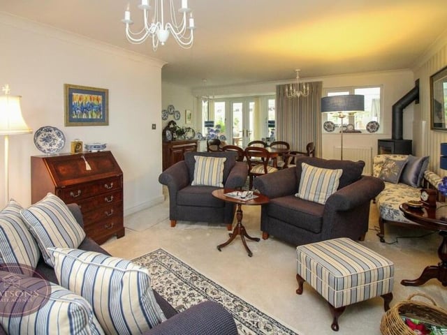A second shot of the lounge and dining area. In the distance, you can see a set of French doors that lead to the conservatory.