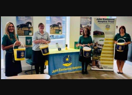 Clare Sears, manager of Lloyds Bank, Kirkby, with staff members taking part in the challenge.