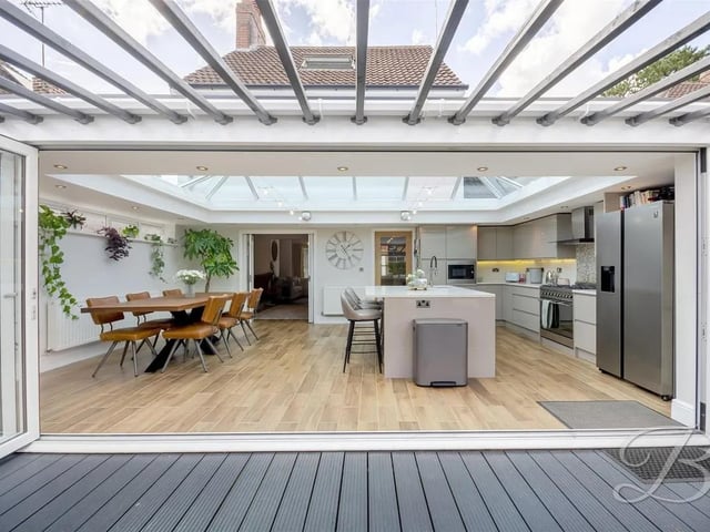 The kitchen is complemented by a skylight and bi-folding doors opening to the rear garden.