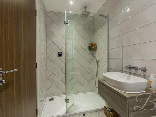 As well as the family bathroom, the Berry Hill property boasts two en suite shower rooms. Here is one of them, complete with shower cubicle, hand wash basin and low-flush WC.