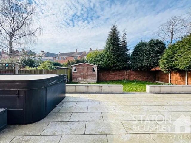 To the rear there is an impressive patio which houses the hot tub as well as a lined area and shed for additional storage