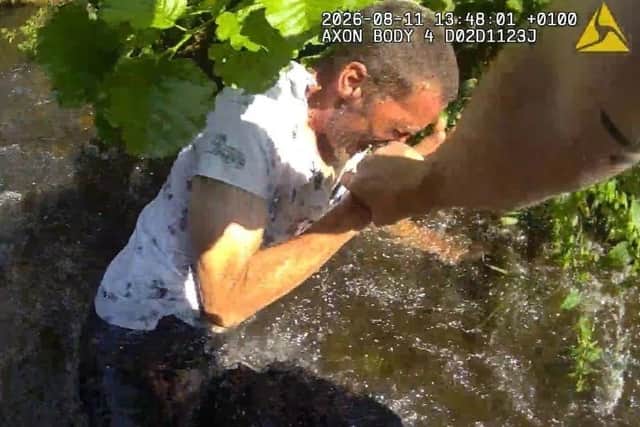 A determined police officer waded into a river to apprehend a shoplifter.