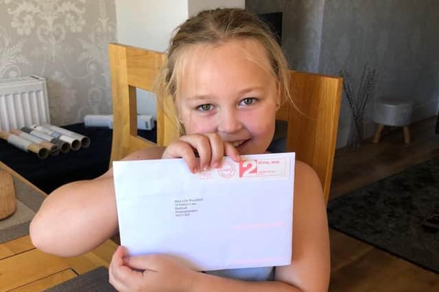 Young Lola Woodfield with her letter from the Queen.