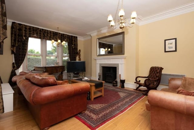 The main reception room on the ground floor is this large living room, which is to the left of the main entrance. It features a lovely bay window and a nice, original fireplace with log burner.